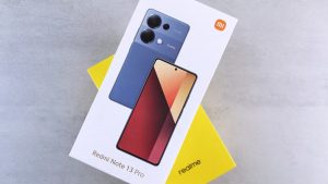 Close-up of Redmi Note 13 Pro phone box with sleek design on neutral background.